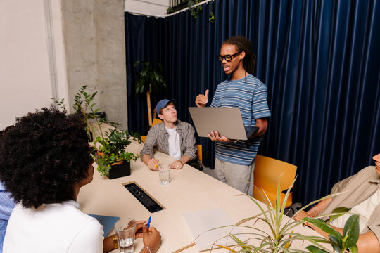 Coworkers engrossed in a brainstorming session in a modern office.