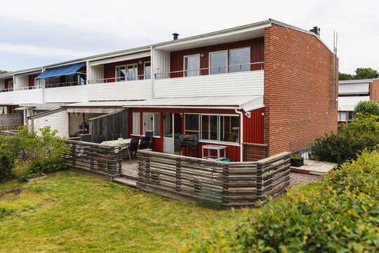 Terraced townhouse backyard with wooden deck patio and lawn