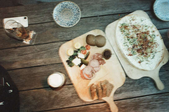 Beer and appetizer boards on weathered outdoor table