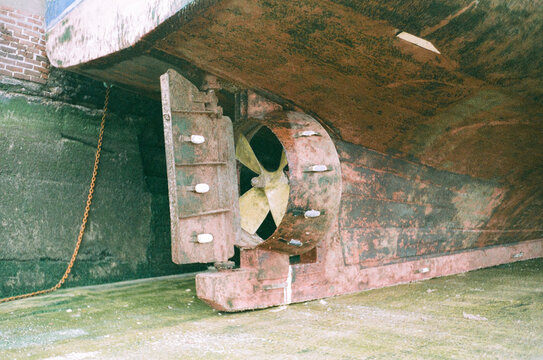 Ship propeller and rudder exposed in dry dock