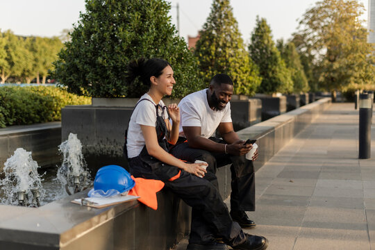 Construction workers enjoying coffee break smiling outdoors
