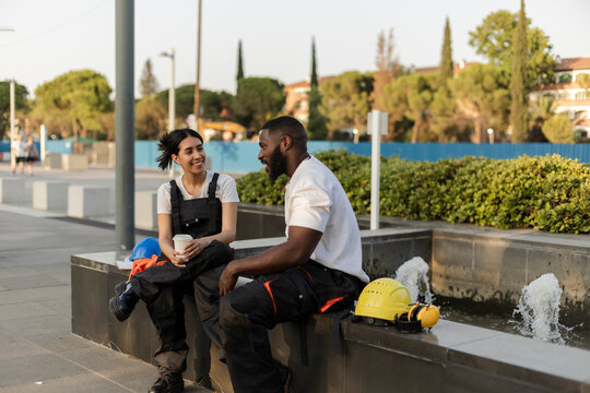 Construction workers sharing coffee break and conversation