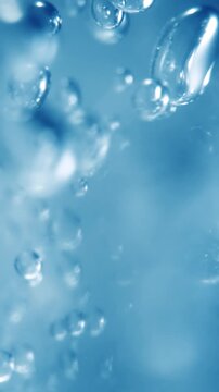 Many water bubbles in blue water close up, abstract water wave with bubbles in slow motion.