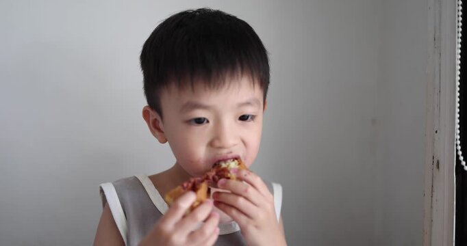 Happy Kid enjoying a slide of waffle