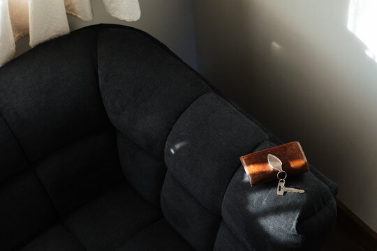 Keys Beside Wallet on Armchair