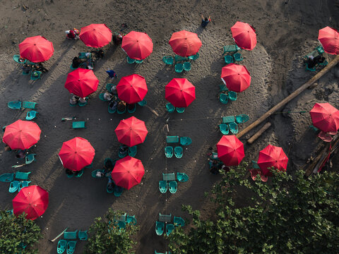 Aerial View of Teal Red Beach Umbrellas Near Trees