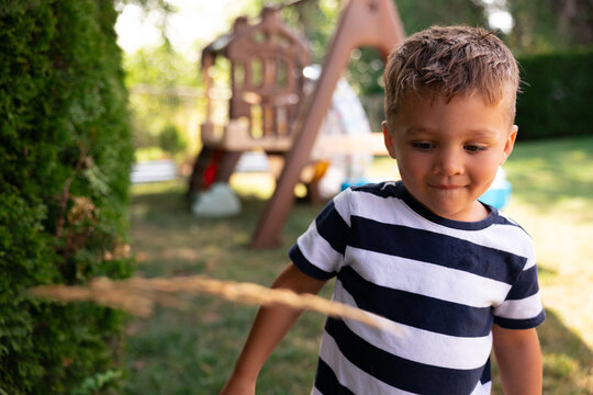 Candid portrait of a young boy playing in backyard playground