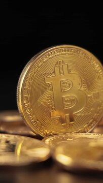 Gold Bit Coin BTC Cryptocurrency Coins on a black background. Bitcoin is a worldwide cryptocurrency and digital payment system called the first decentralized digital currency.