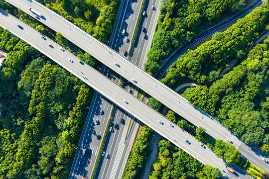 highway interchange curving through lush green forest