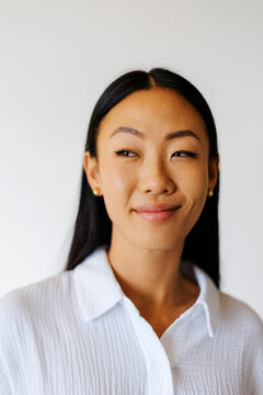 Woman looking sideways smiling with engaging expression