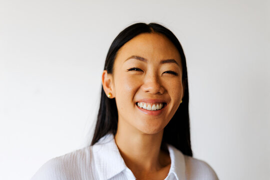 Woman smiling eyes closed expressing happiness and joy