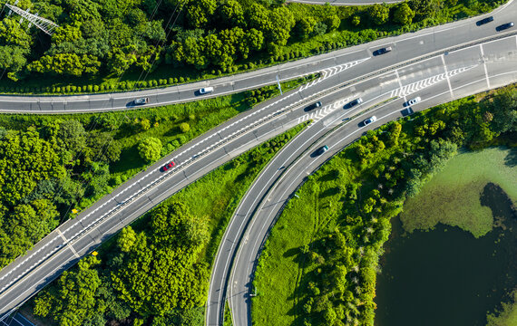 highway interchange curving through lush green forest