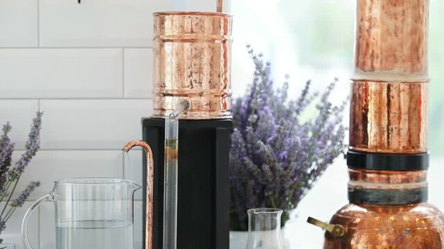 Distillation of lavender essential oil and hydrolate. Copper alambik for the flowering field.