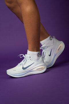 Riga, Latvia - August 03 2026 - Closeup of a new NIKE sport shoes isolated on purple background