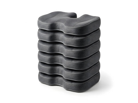 Stack of ergonomic office seat cushions isolated on a white background