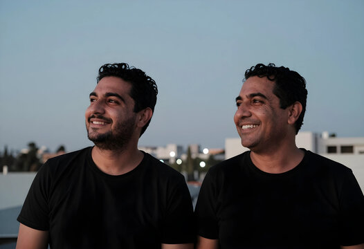 Optimism and future vision, two men looking ahead with hope and confidence in an urban outdoor setting at dusk for personal growth and success concepts