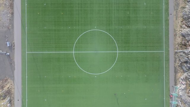 Aerial view of soccer field center circle with white markings on green grass in Vagan Municipality, Nordland, Norway.