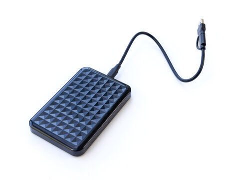 Black external hard drive connected with a cable