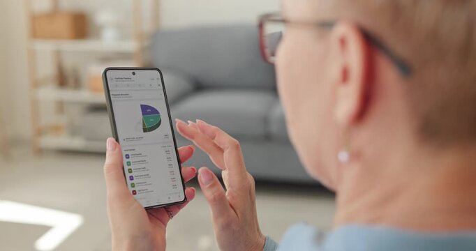 Woman reviews investment portfolio charts on smartphone. She checks mobile finance data and allocation charts for wealth management and retirement planning. A modern personal finance concept.