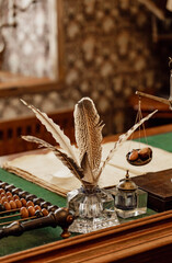 still life with feather and book © Yuliia
