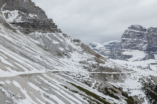 A winter scene in the Dolomites, Italy, features snow covered mountains and trails, inviting winter tourism in the Italian Alps.