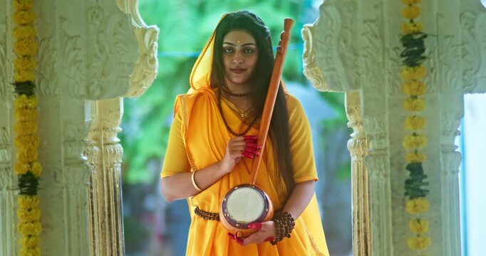 Saint Mirabai Entering a Traditional Hindu Temple and Worshipping Lord Krishna. Rajasthani saint devoted to Krishna performs prayers and devotional rituals inside the temple.