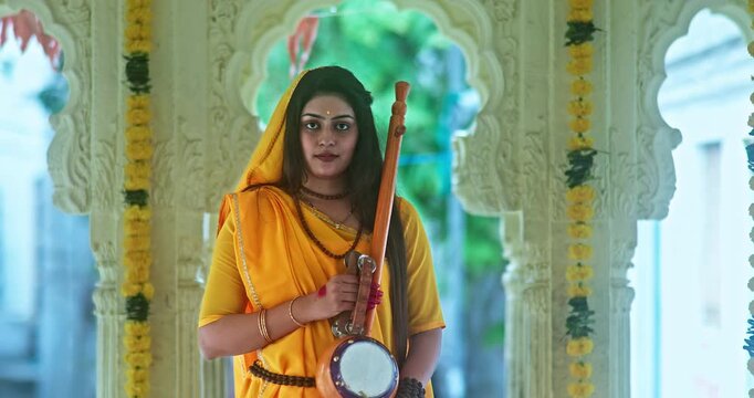 Saint Mirabai Entering a Traditional Hindu Temple and Worshipping Lord Krishna. Rajasthani saint devoted to Krishna performs prayers and devotional rituals inside the temple.