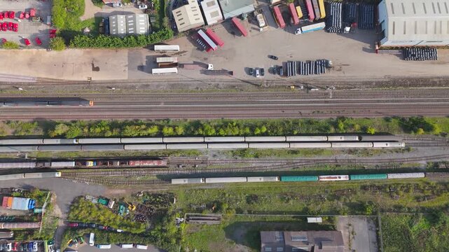 Aerial view of a passenger train moving along railway tracks