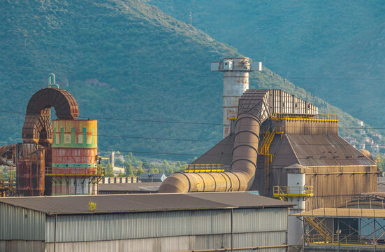 Aerial view of heavy industrial ventilation and air filtration equipment with massive exhaust ducts at a manufacturing plant in Brescia, Lombardy, Italy.
