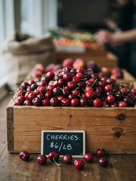 Freshly harvested cherries in wooden crates on a rustic