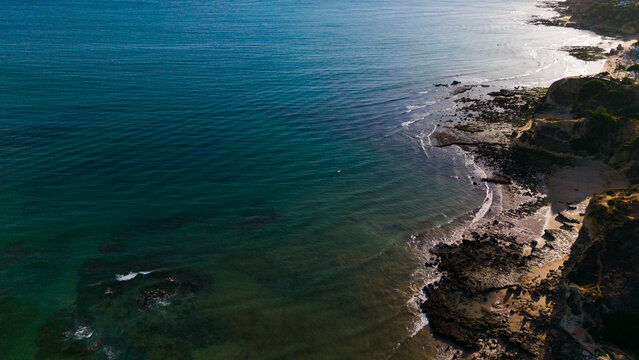 Aerial rocks and cliffs seascape shore view of beach, Algarve. Praia do Barranco das Belharucas