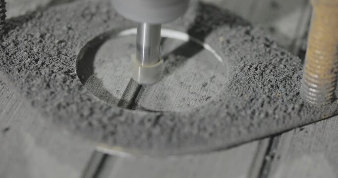 A high-precision CNC routing process of material for yacht and motorboat deck flooring. The working cutter is carving longitudinal grooves and channels on a panel used for ship deck finishing. 