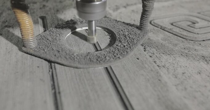 A high-precision CNC routing process of material for yacht and motorboat deck flooring. The working cutter is carving longitudinal grooves and channels on a panel used for ship deck finishing.