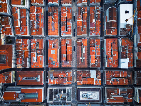 Aerial view of the historic city center of Lisbon with its characteristic red-tiled rooftops, narrow streets, and dense urban architecture in Lisbon, Lisbon, Portugal.