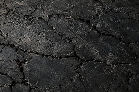 Dark slate gray cracked industrial vulcanized rubber belt surface