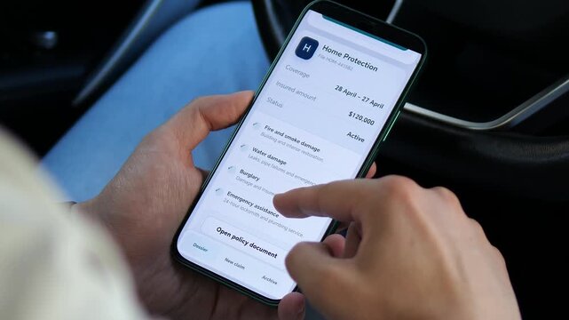 Person reviews car and home insurance policies on a smartphone, comparing coverage, exclusions and claim rules as digital insurance reshapes risk management.