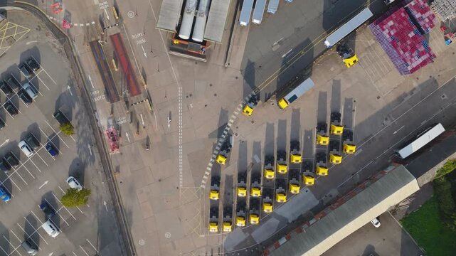 Overhead view of yellow tug vehicles parked in industrial depot