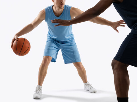Basketball player facing defensive pressure in studio
