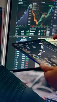 Tablet Financial Stock Market Dashboard Analytics Charts. A close-up view of a professional investor analyzing real-time financial market data and trading stock charts on a digital tablet screen
