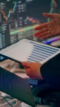 Analyst Holding Digital Tablet Revenue Growth Bar Chart Display. A professional business manager analyzing financial statistics and revenue bar charts on a digital tablet in a modern office setup