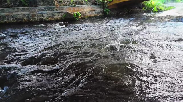 Fast Flowing River Water Cascading Over Rocky Stream Bed in Natural Environment
