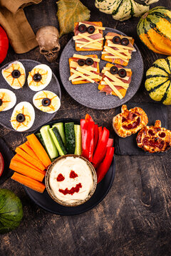 Halloween appetizers with pumpkin hummus deviled eggs and mummy snacks