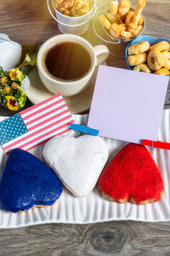 American patriotic Patriotic breakfast with heart shaped cookies, coffee cup and blank note card on wooden background