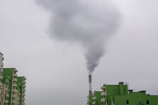 Environmental problem of city air pollution - Industrial construction cranes and building site over Steam and smoke emissions. grunge filter photo	