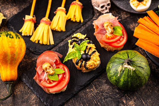 Halloween appetizers with pumpkin hummus deviled eggs and mummy snacks