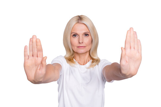 Photo portrait of serious old woman showing two palms signaling to stop isolated on grey colored background