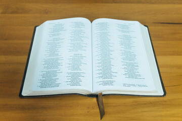 Fototapeta premium Bible on Wooden Table with Bookmark, Christian Faith and Spirituality Concept