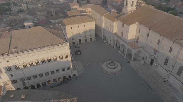 Aerial view of the historic Piazza IV Novembre with its iconic Fontana Maggiore surrounded by medieval buildings and stone architecture in Perugia, Umbria, Italy.