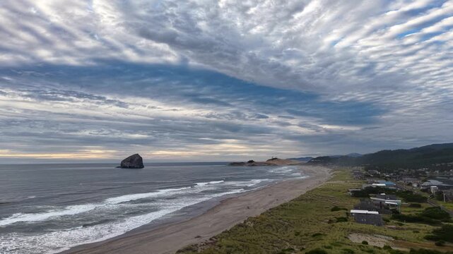 OREGON - 9.2.2026 - Stunning aerial panorama shifting from Oregon's Pacific City Beach towards Chief Kiawanda Rock in the ocean.