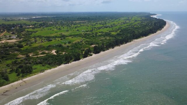 SENEGAL - 11.10.2025 - Beautiful aerial footage approaching a green coastline of Senegal from the ocean.